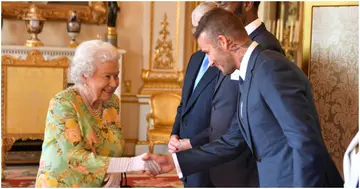 David Beckham greets Queen Elizabeth II at Buckingham Palace on June 26, 2018.