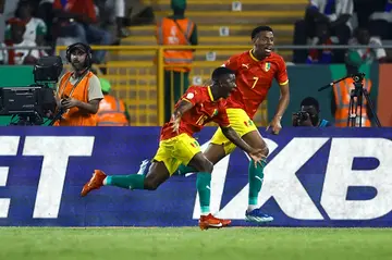 Aguibou Camara (L) celebrates scoring Guinea's winning goal against Gambia