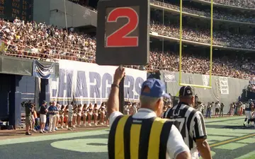 A San Diego Chargers Chain Gang member holds down an indicator at a game against the Seattle Seahawks, circa 1999, in San Diego, California