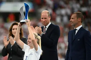 Beth Mead holds up her trophy for player of the tournament in front of Prince William and UEFA president Aleksander Ceferin