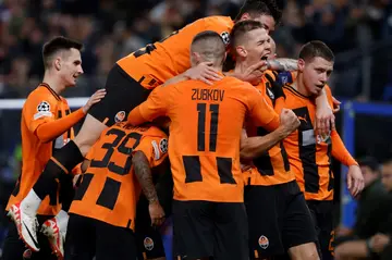 Shakhtar Donetsk players celebrate Danylo Sikan's (2R) header which won them the match against visitors Barcelona on Tuesday
