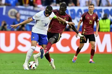 Kylian Mbappe holds off Amadou Onana during the Euro 2024 last-16 clash between France and Belgium in Duesseldorf on Monday