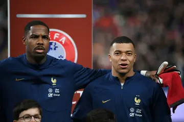 Mike Maignan (L) and Kylian Mbappe sing the French anthem together ahead of a match against the Netherlands earlier this year