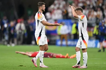 Niclas Fuellkrug (L) and Joshua Kimmich celebrate Germany's draw with Switzerland