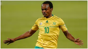 Percy Tau celebrates during the Qatar 2022 FIFA World Cup qualifying match between South Africa and Zimbabwe.