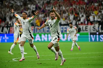 Niclas Fuellkrug and his Germany team-mates celebrate his last-gasp equaliser against Switzerland