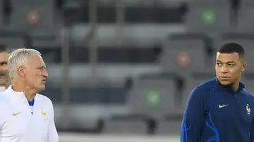 France coach Didier Deschamps talks to Kylian Mbappe during a training session