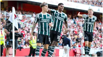 Manchester United's Rasmus Hojlund, Marcus Rashford, and Alejandro Garnacho celebrate before the latter's goal is ruled out for offside during the Premier League match between Arsenal and Manchester United at the Emirates Stadium.