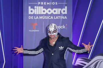 Rey Mysterio gestures backstage at the Watsco Centre