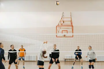 Group of people wearing sportswear playing volleyball