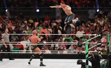 John Cena (R) competes with Triple H during WWE