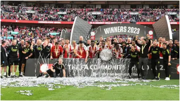 The Arsenal team and staff with the Community Shield after The FA Community Shield match between Manchester City against Arsenal at Wembley Stadium. Photo by David Price.