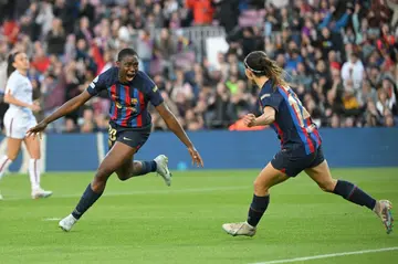 Barcelona's Nigerian forward Asisat Oshoala (L) celebrates scoring against Roma in the women's Champions League quarter-finals