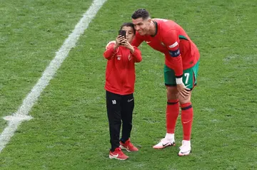 The first of several pitch invaders at Portugal's game against Turkey was successful in obtaining a selfie with Cristiano Ronaldo