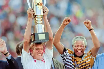 South Africa captain Neil Tovey lifts the Africa Cup of Nations trophy in 1996 as then President Nelson Mandela celebrates.