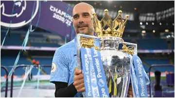 Pep Guardiola celebrates with the Premier League trophy at the Etihad Stadium. Photo by Michael Regan.