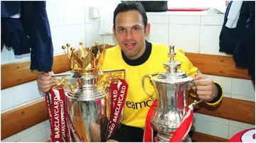 Richard Wright poses with the Premier League trophy and the FA Cup Trophy after the match between Arsenal and Everton in 2002. Photo by Stuart MacFarlane.