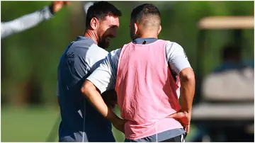 Lionel Messi and Jordi Alba speak on the field during a training session at Florida Blue Training Center. Photo by Megan Briggs.