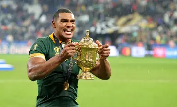Damian Willemse raises the Webb Ellis Cup after their victory during the South Africa captain's run