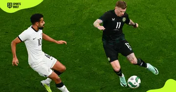 Ireland's James McClean (r) in action against New Zealand's Sarpreet Singh (l).