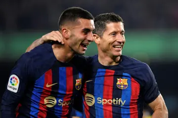 Barcelona's Polish forward Robert Lewandowski (R) celebrates scoring his team's second goal against Cadiz with Ferran Torres (L)