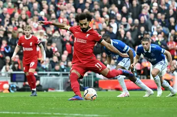 Mohamed Salah scores the opening goal from the penalty spot as Liverpool beat Everton