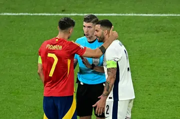 French referee François Letexier speaks with Spain captain Alvaro Morata and England captain Kyle Walker during the Euro 2024 final