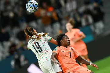 Netherlands forward Lineth Beerensteyn and Portugal defender Diana Gomes (L) fight for the ball