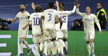 Real Madrid's players celebrate after Real Madrid's French forward Karim Benzema (L) scored a goal during the UEFA Champions League round of 16 (Photo by JAVIER SORIANO)