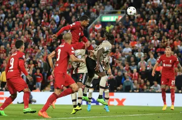 Joel Matip (centre) rose highest to head home Liverpool's late winner against Ajax