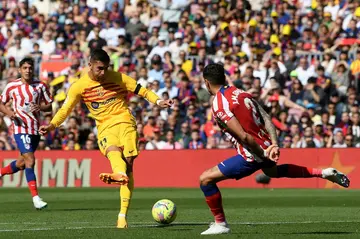 Barcelona's Spanish forward Ferran Torres (L) scores his team's winner against Atletico Madrid on Sunday