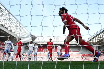 Mohamed Salah (R) celebrates scoring for Liverpool against Aston Villa at Anfield.