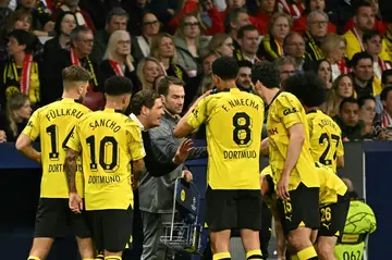 Borussia Dortmund coach Edin Terzic (3rd L) talks to his players during the first leg of their Champions League quarter-final against Atletico Madrid