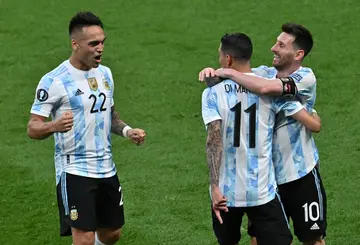 Angel Di Maria (centre) celebrates scoring a goal with his former club teammate at PSG Lionel Messi (right) and Lautaro Martinez during a friendly victory over Italy in London in June 2022
