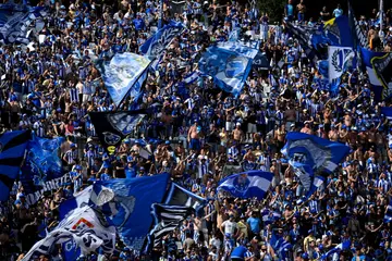 Porto's supporters wave flags before the "Taca de Portugal" (Portugal's Cup) final football match against SC Braga in Oeiras on June 4, 2023