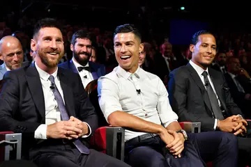 Cristiano Ronaldo and Lionel Messi react during the UEFA Champions League Draw at Salle des Princes. Photo by Harold Cunningham.