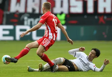 On the slide: Union Berlin midfielder Andras Schaefer (left) skips past Daichi Kamada