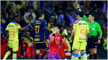 Adonai Escobedo shows the red card to Nahuel Guzman during the final second-leg match between America and Tigres UANL. Photo by Manuel Velasquez.