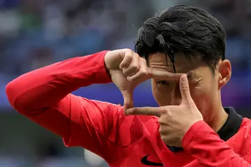 Son Heung-min celebrates after scoring a penalty against Malaysia