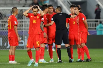 China's players remonstrate with the referee after their goal is disallowed