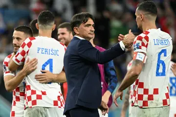 Croatia coach Zlatko Dalic (C) congratulates defender Dejan Lovren after beating Japan at the World Cup