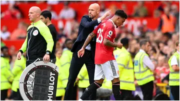 Erik ten Hag interacts with Jadon Sancho during the Premier League match between Manchester United and Arsenal FC at Old Trafford. Photo by Michael Regan.