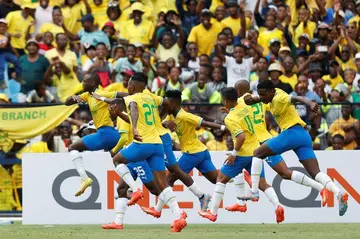 Mamelodi Sundowns star Peter Shalulile (L) celebrates a goal with teammates