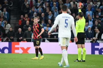 Manchester City defender Sergio Gomez is shown a red card by Artur Dias