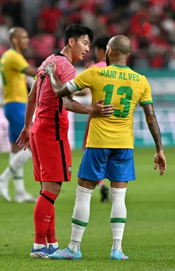 Son Heung-min (L) with Dani Alves during the friendly match between South Korea and Brazil in Seoul in June