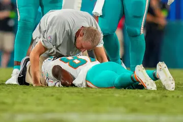 Miami Dolphins receiver Daewood Davis is examined by medical staff after an injury on Saturday that brought an early halt to an NFL pre-season game at Jacksonville