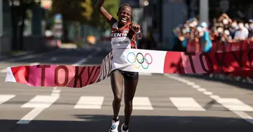 Peres Jepchirchir celebrates as she crosses the finish line to win the gold medal in the Women's Marathon Final on day fifteen of the Tokyo 2020 Olympic Games at Sapporo Odori Park (Photo by Clive Brunskill/Getty Images)