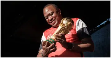 President Uhuru Kenyatta holds the FIFA World Cup Trophy during its World Tour at the State House in Nairobi on February 26, 2018. Photo by YASUYOSHI CHIBA.
