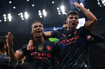Manchester City defender Nathan Ake (L) celebrates his winner at Tottenham
