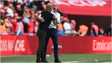Erik ten Hag embraces Pep Guardiola during the Emirates FA Cup Final between Manchester City and Manchester United at Wembley Stadium. Photo by Mike Hewitt.